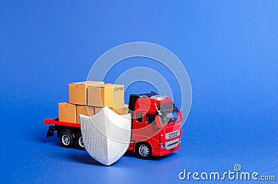 Red truck with a load of boxes behind the shield. Cargo insurance, transportation safety. Guaranteed quality and speed of delivery Stock Photo