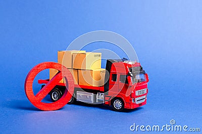 A red truck loaded with boxes and a red symbol NO. Embargo trade wars. Restriction on importation, ban on export of dual-use goods Stock Photo
