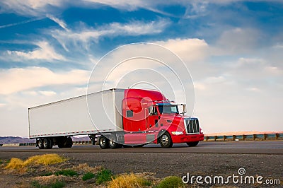 Red truck moving on a highway Stock Photo