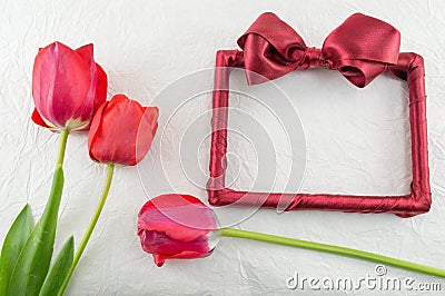 Red tulips on a silk fabric Stock Photo