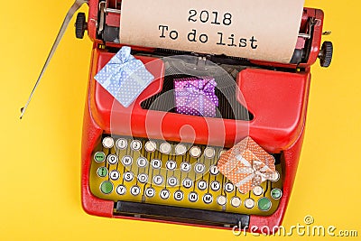 red typewriter with the text "2018 To do list" and gift boxes on yellow background Stock Photo