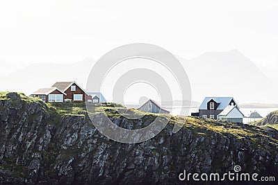 Red typical Icelandic wooden houses on the edge of a cliff near sea - Stykkisholmur Stock Photo