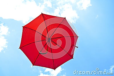 Red umbrella flying on blue sky Stock Photo