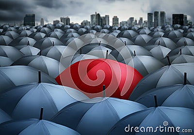 Red umbrella outstanding from the others Stock Photo