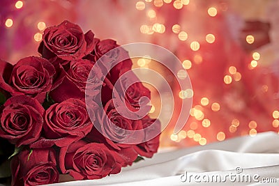 Red valentine roses bouquet with white feathers Stock Photo