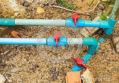 Red valve on water pipelines. Stock Photo