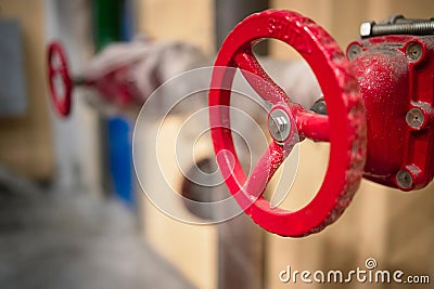 Red valves on hydrant pipelines of security and fire extinguishing systems of modern chemical production with copy space Stock Photo