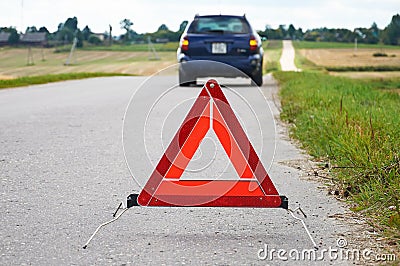 Red warning triangle and broken down car Stock Photo