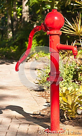 Red water hand pump Stock Photo