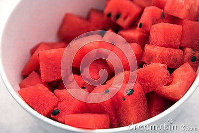 Red watermelon slices in a white bowl, fresh cool snack Stock Photo