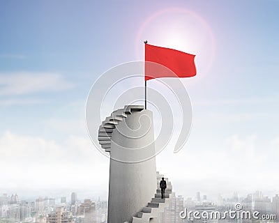 Red wavy flag on tower top with stairs Stock Photo