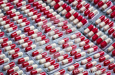 Red-white antibiotic capsule pills in blister pack. Antibiotic drug resistance concept. Pharmaceutical industry. Pharmacy Stock Photo