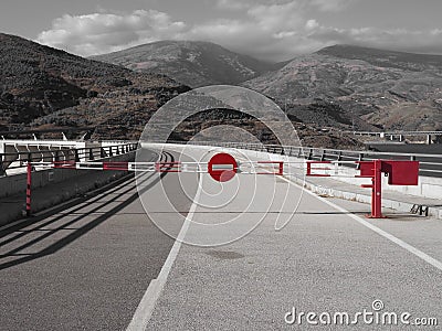 Red and white Barrier with a stop sign on a closed road Stock Photo