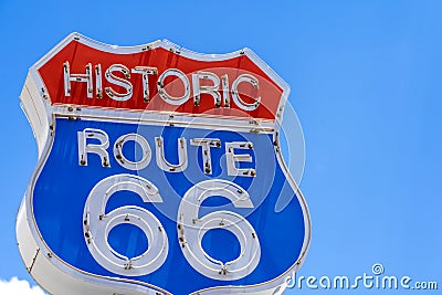 Red, white and blue Route 66 sign in front of blue sky Stock Photo