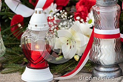 Red and white candles and flowers in the colors of the Polish flag, national anniversary in Poland. Polish national colors Stock Photo