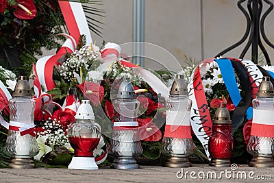 Red and white candles and flowers in the colors of the Polish flag, national anniversary in Poland. Polish national colors Stock Photo