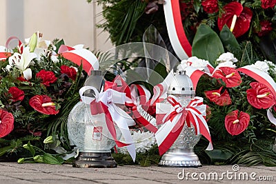 Red and white candles and flowers in the colors of the Polish flag, national anniversary in Poland. Polish national colors Stock Photo