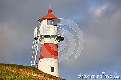 Red and white classic lighthouse. Faroe islands, Torshavn harbor Stock Photo