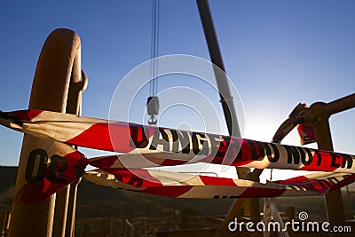 Red and white danger tag tape sign on exclusion zone taping off working area dropped object crane lifting high risk work Stock Photo