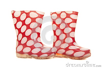 Red and white dotted kids rain boots on a white background Stock Photo