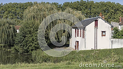 Red and white french house with external attic ladder Stock Photo