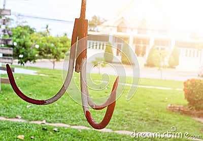 Red and white iron hooks, blurred background in industrial applications. Stock Photo