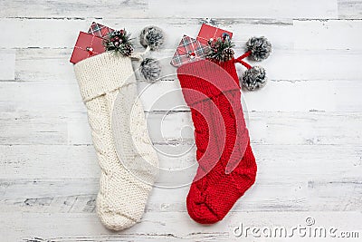 Red and white knitted Christmas stockings on white wood background Stock Photo