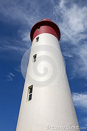 Red and White Lighthouse Extending Towards Blue Cloudy Sky Stock Photo