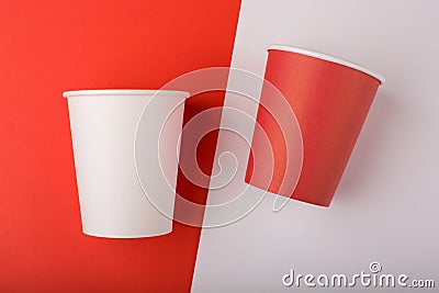 Red and white paper cup on colored background. Stock Photo