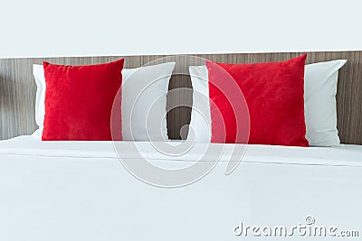 Red and white pillows on a bed Stock Photo