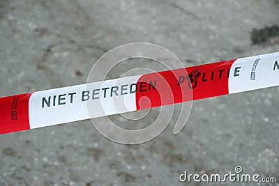 Red white tape with dutch text Niet Betreden, Politie which means no trespassing police to be used by the police in the Netherland Editorial Stock Photo