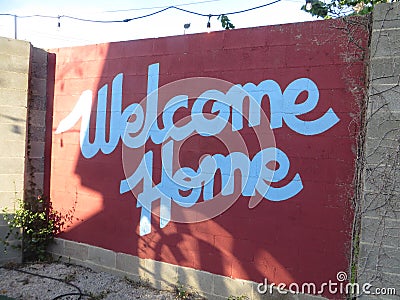 Red and white welcome home sign Stock Photo