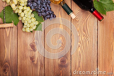 Red and white wine bottles and bunch of grapes Stock Photo
