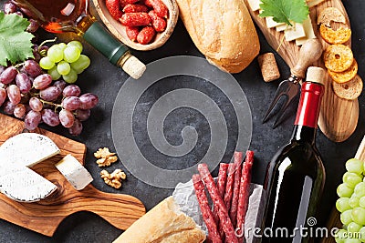 Red and white wine, grape, cheese and sausages Stock Photo