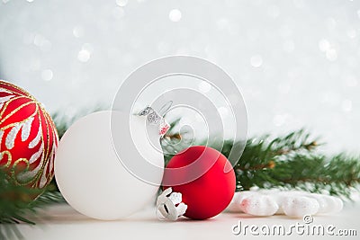 Red and white xmas ornaments on glitter holiday background. Merry christmas card. Stock Photo