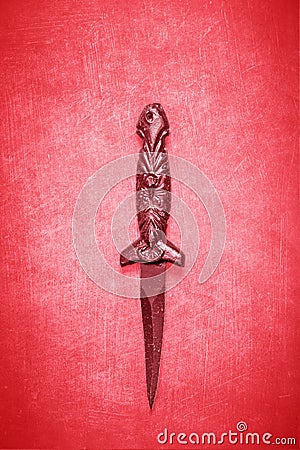 Red Wiccan dagger on a red background Stock Photo