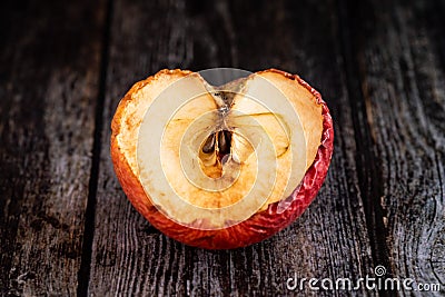 Red wilted rotten half apple details. Close up photo Stock Photo