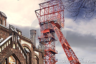 Red winding tower of the former Bonifacius colliery behind the facade of a hotel in a converted colliery building Editorial Stock Photo