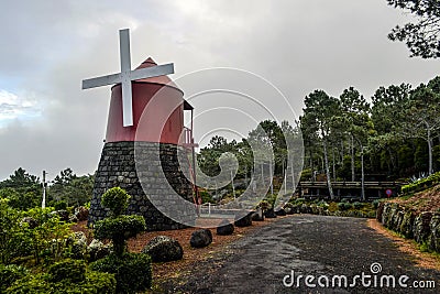 Red windmill on the coast of Pico Island Stock Photo