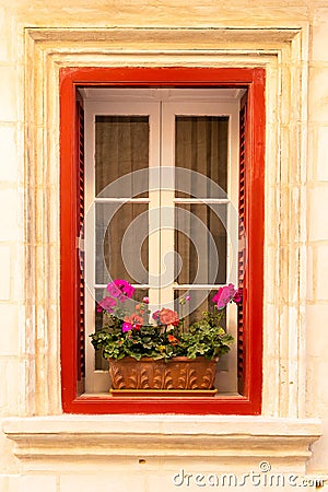 Red window with geraniums colorful flowers in clay pot Stock Photo