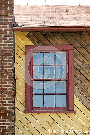 Red window on yellow diagonal wood with red brick Stock Photo