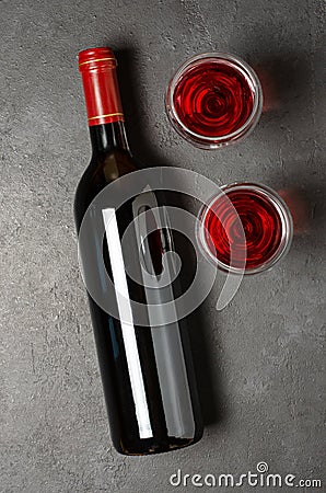 Red wine in a bottle. Black concrete background. Flat lay Stock Photo