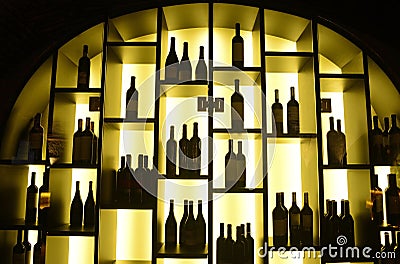 Bottles on Lighted Shelves, Red and White Wine Restaurant Business Editorial Stock Photo