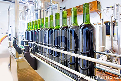 Red wine in bottling machine at winery Stock Photo