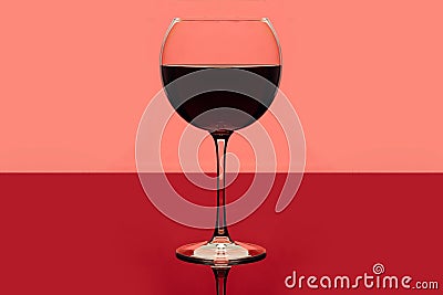 Red wine. Drink glass of red wine on a pink and red background. Alcoholic beverage. Romantic evening or loneliness Stock Photo