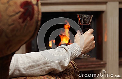 Red wine by the fireplace Stock Photo