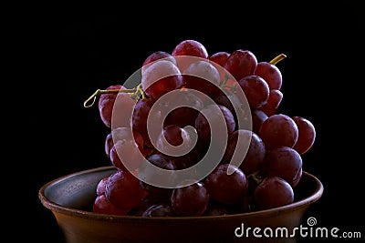 Red wine flow from a cluster of grapes Stock Photo