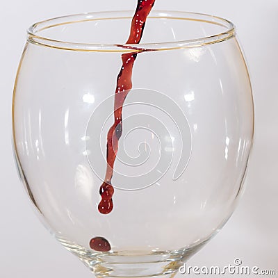 Red wine flow into glass macro Stock Photo
