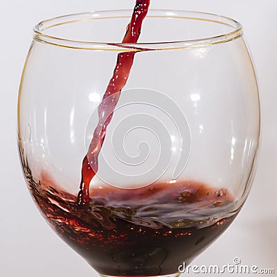 Red wine flow into glass macro Stock Photo