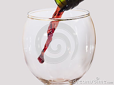 Red wine flow from a green bottle Stock Photo